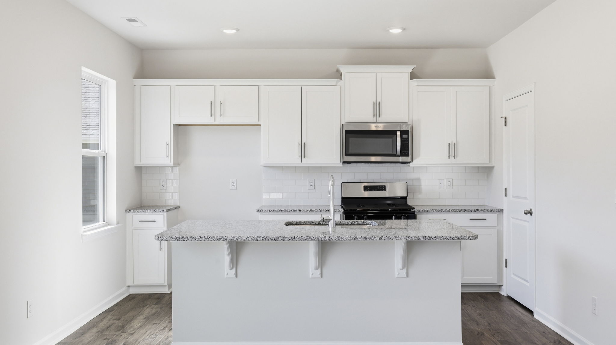 Open concept kitchen with large island and stainless steel appliances