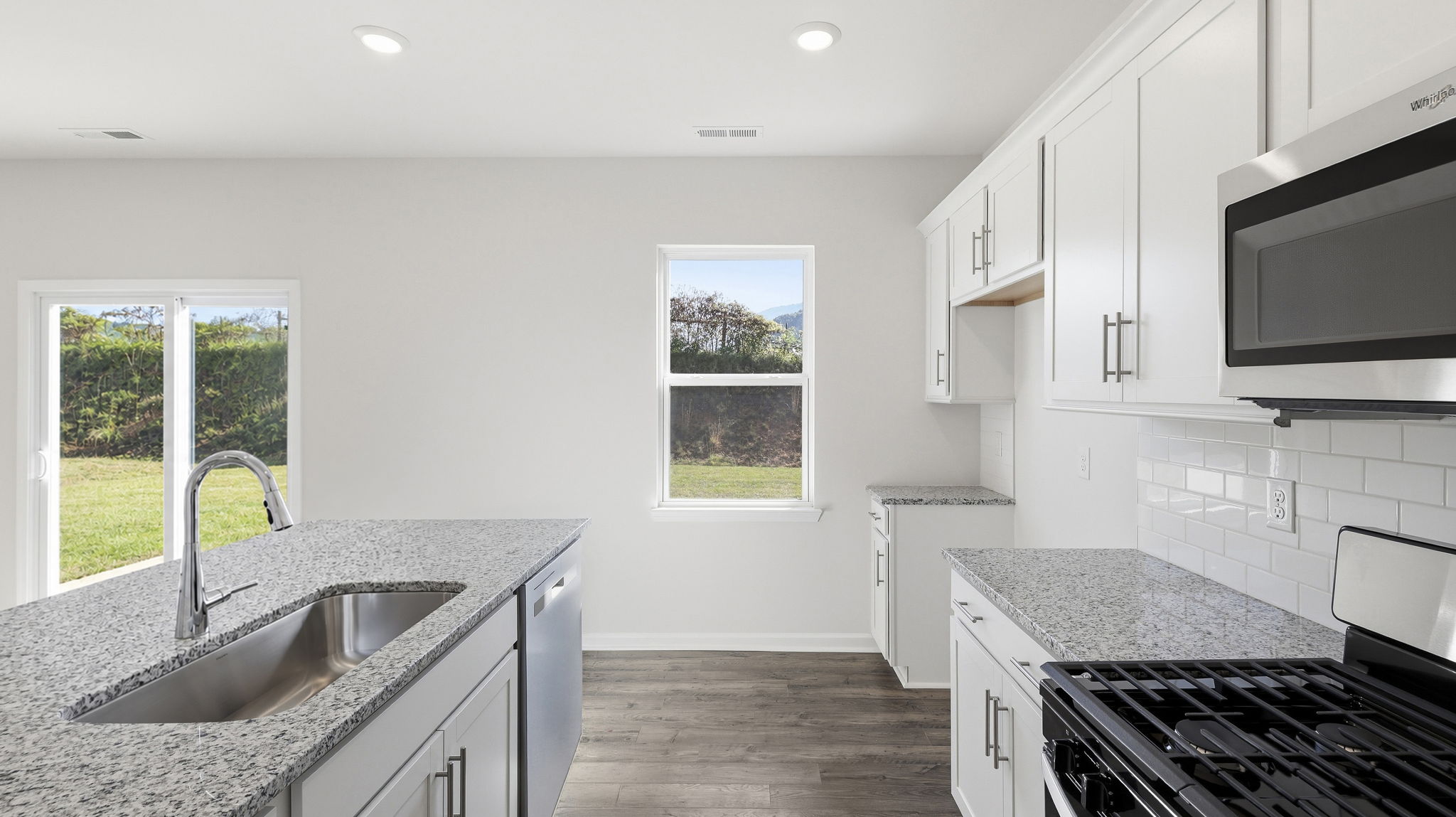 Open concept kitchen with large island and stainless steel appliances