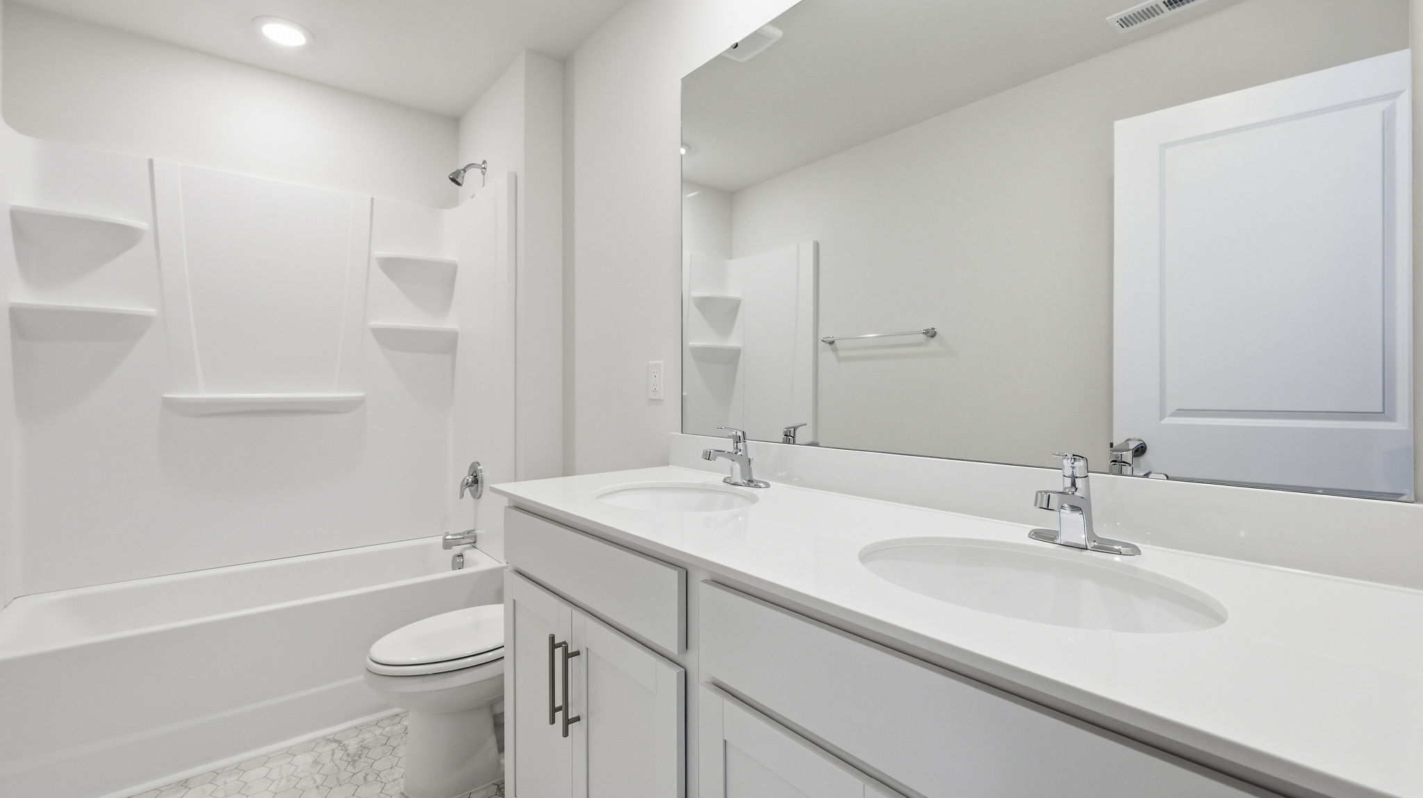 Bathroom with dual vanity and bathtub