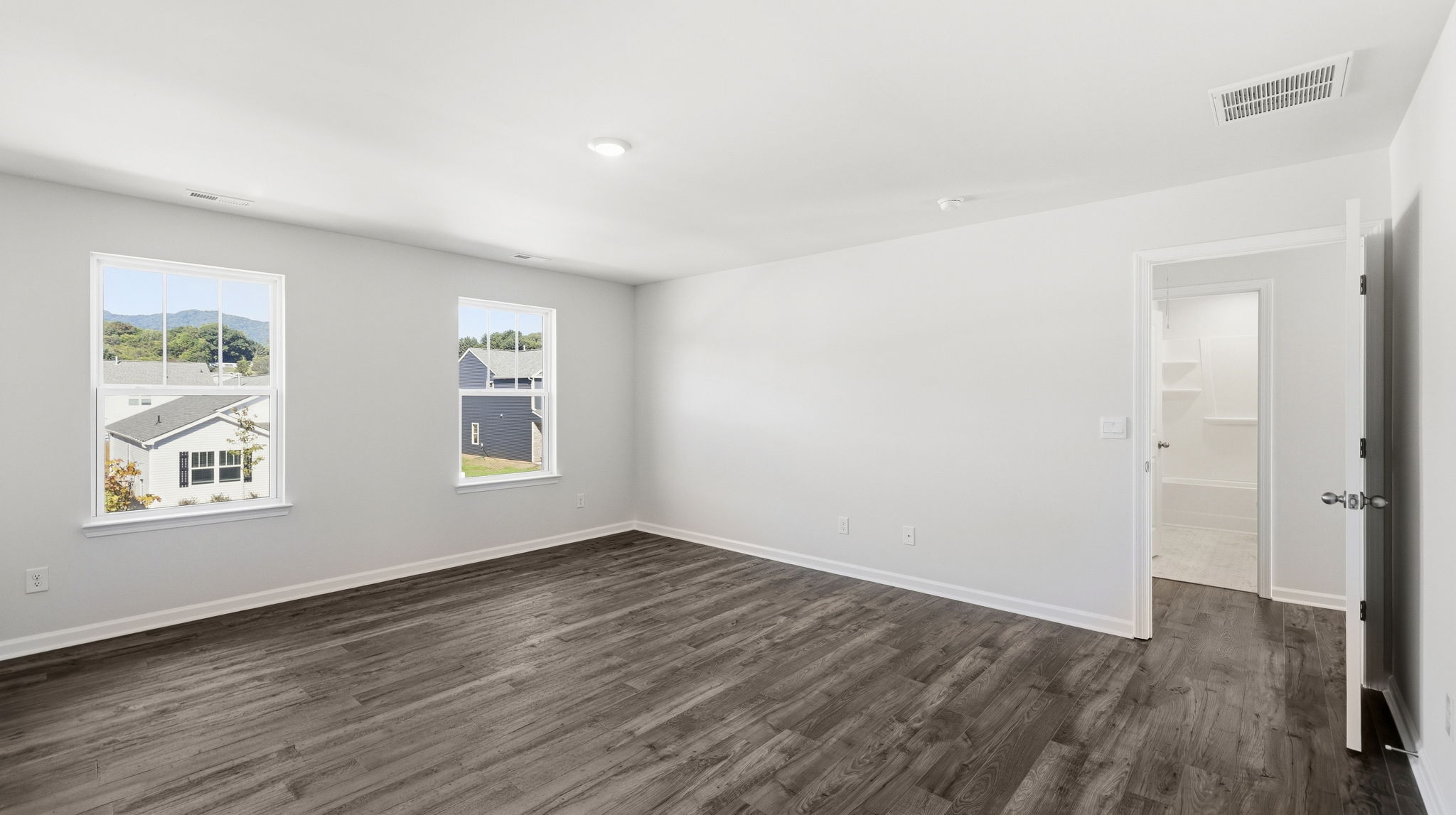 Primary bedroom with multiple windows