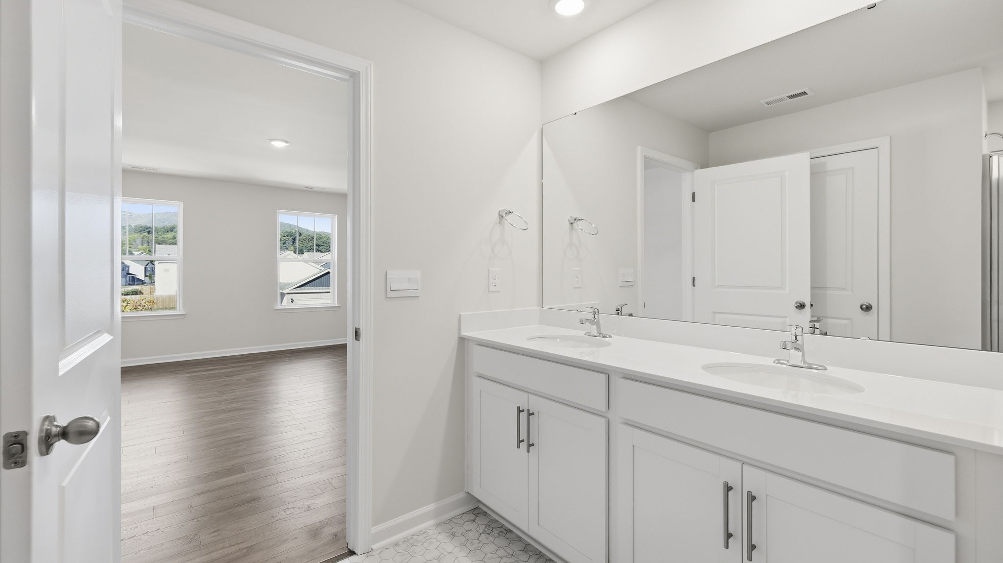 Primary bathroom with dual vanity and walk in shower