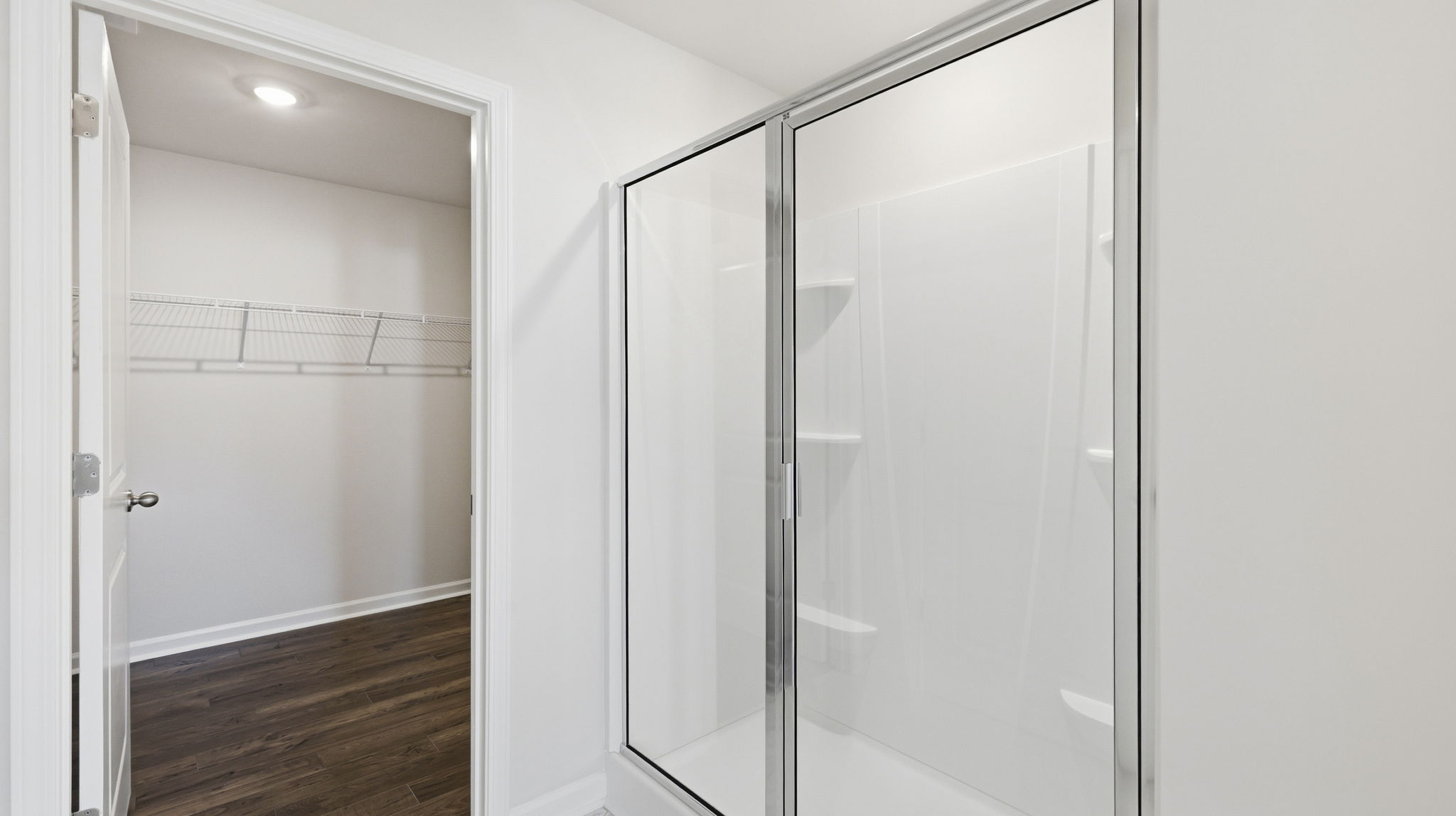 Primary bathroom with dual vanity and walk in shower