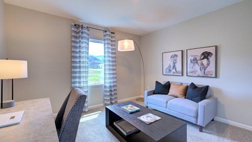 Carpeted bedroom used as an office space with small window