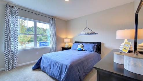 Carpeted bedroom with large window