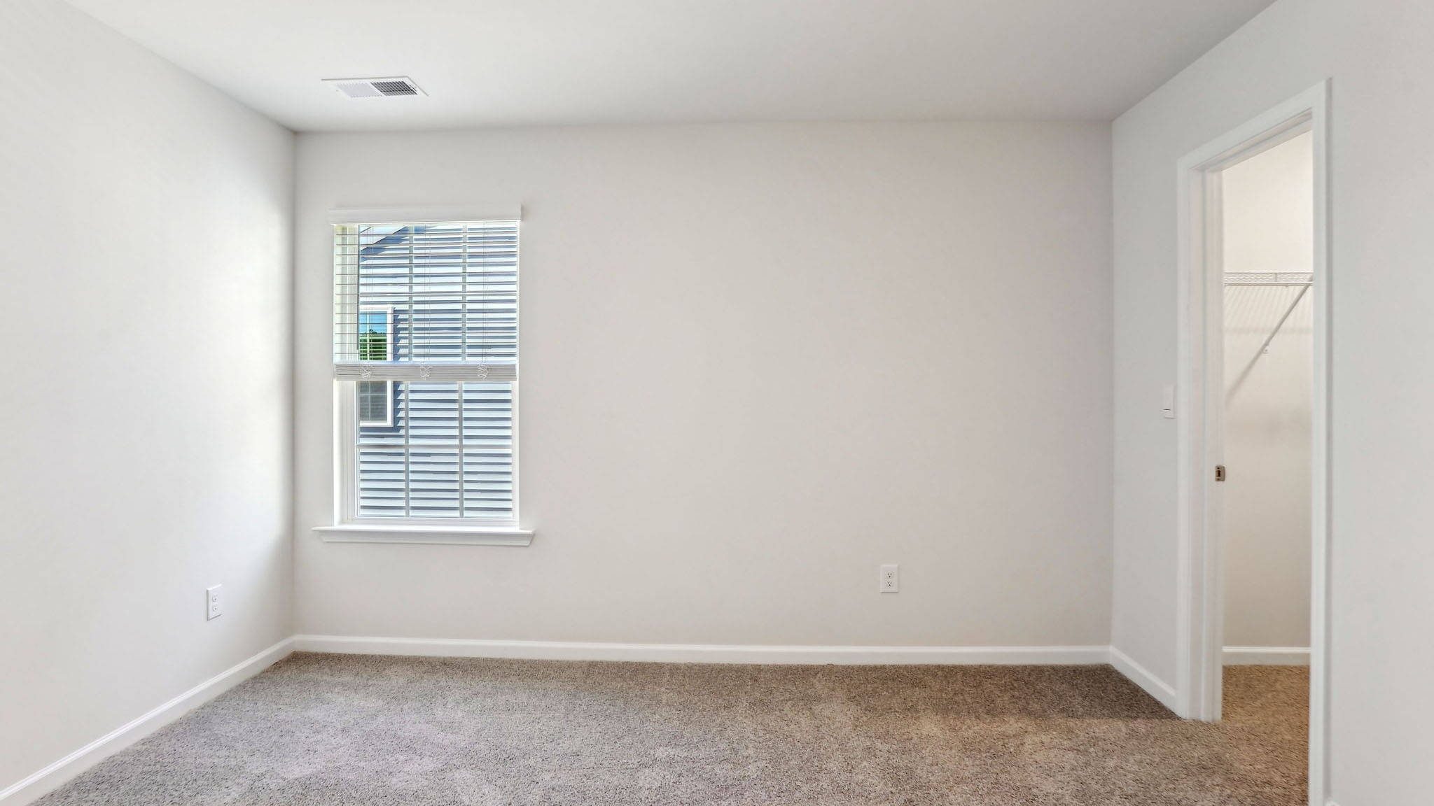 Carpeted bedroom with window