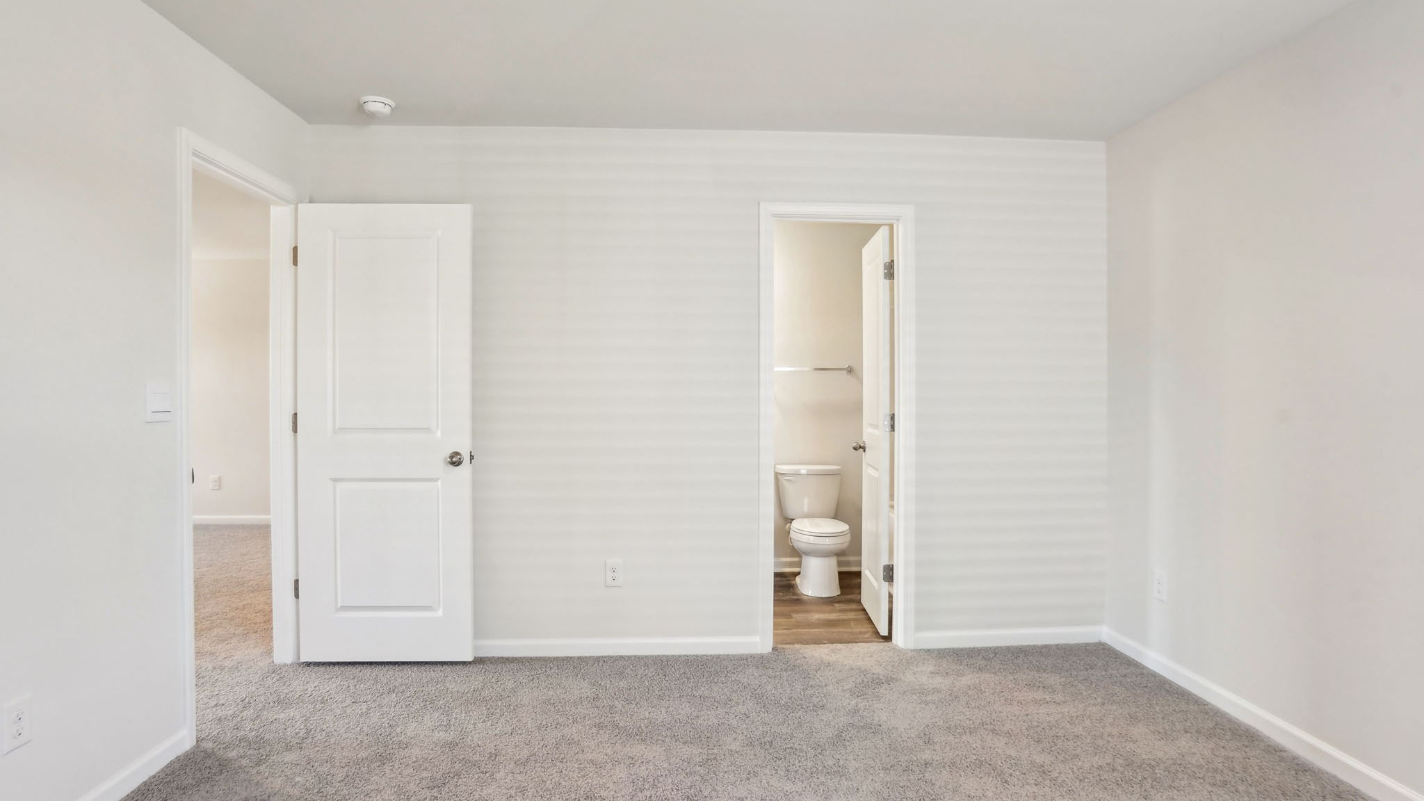 Carpeted bedroom with window