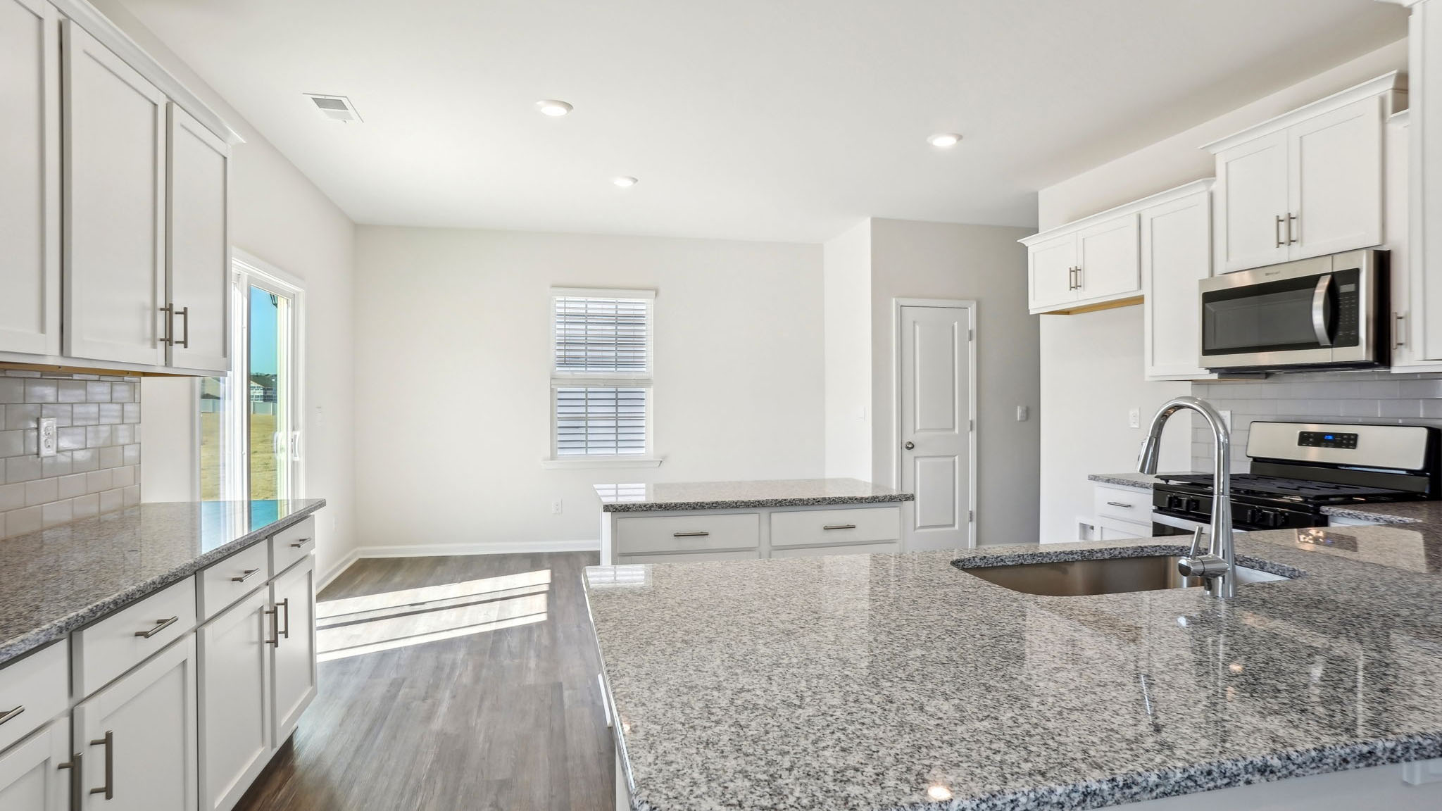 Open kitchen with island and stainless steel appliances