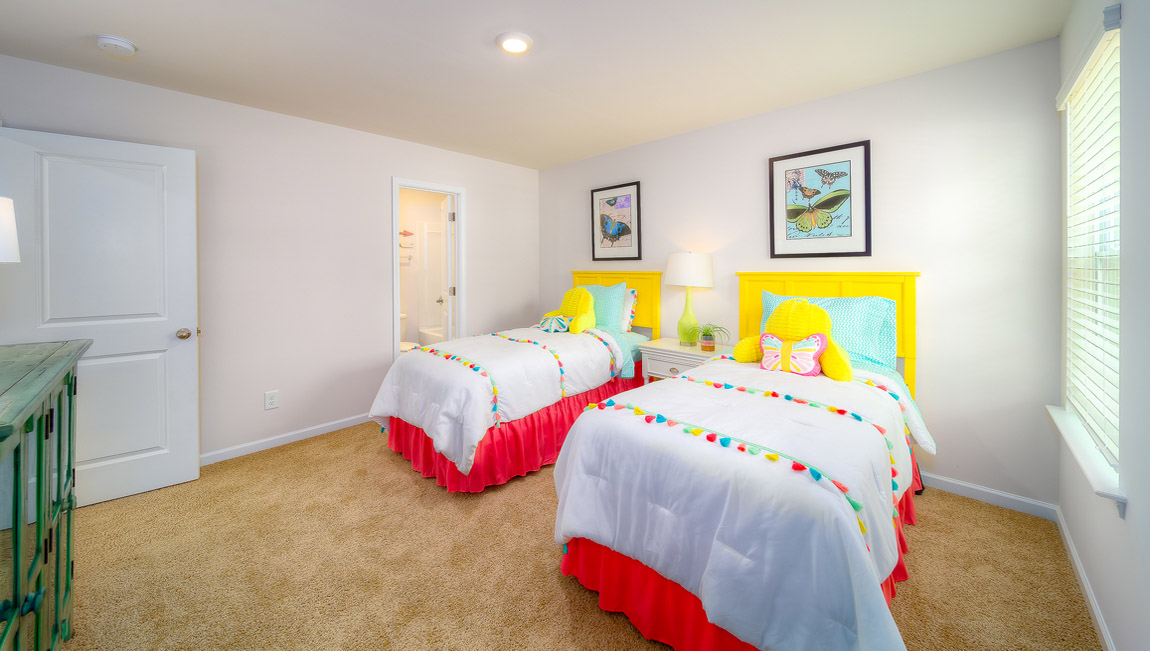 Carpeted bedroom with large window