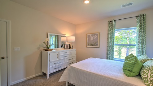 Carpeted bedroom with small window