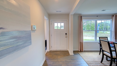 Welcoming foyer with dining room beside and large window