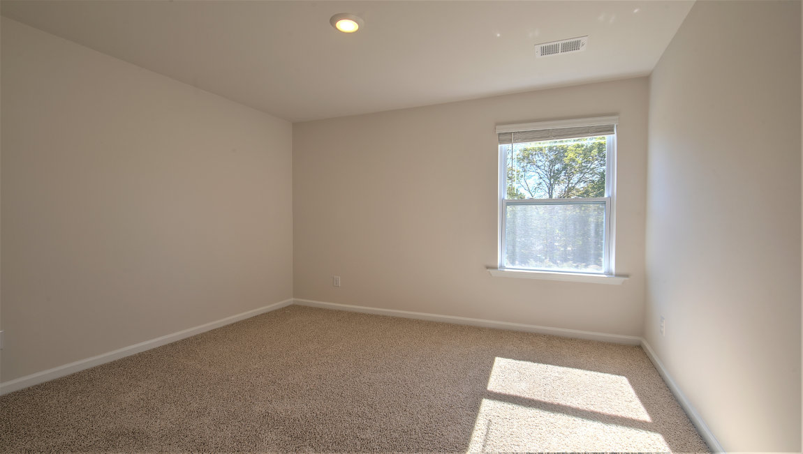 Carpeted bedroom with large window