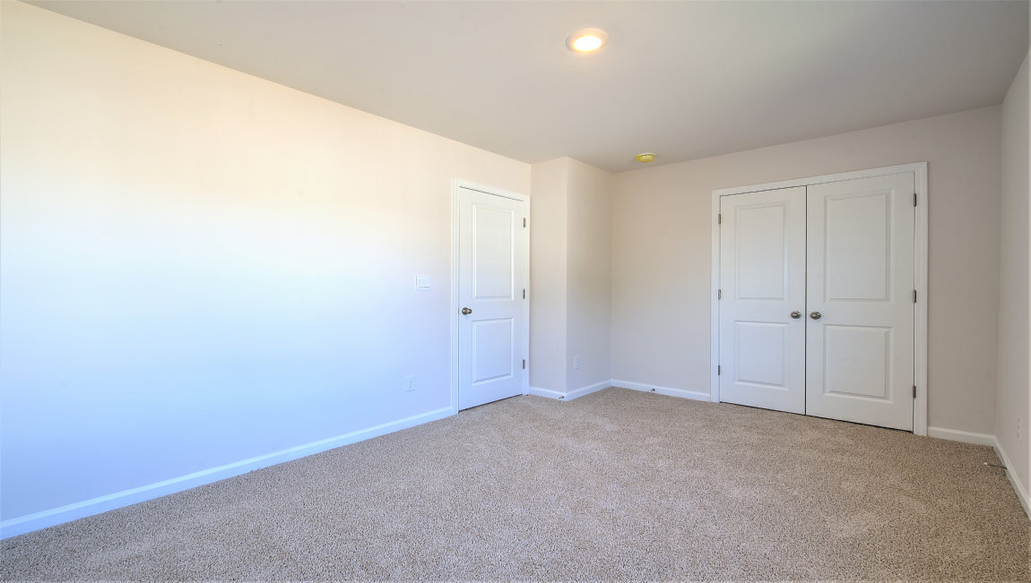 Carpeted bedroom with large window