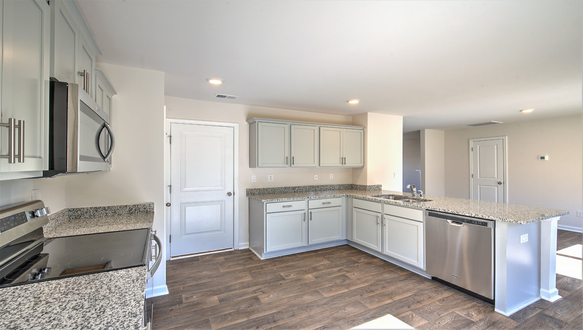 Kitchen with white cabinets, granite countertops and stainless steel appliances