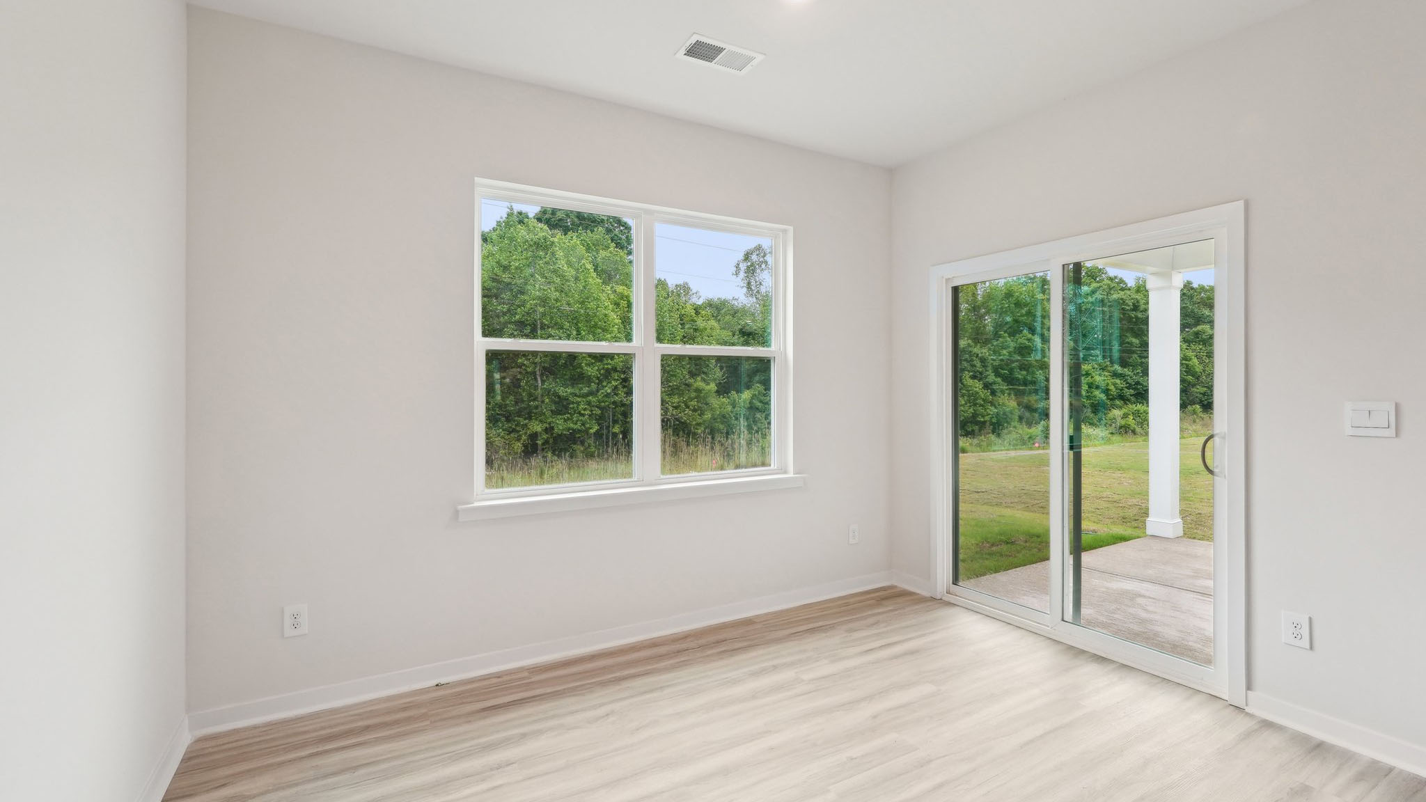 Carpeted bedroom with large window