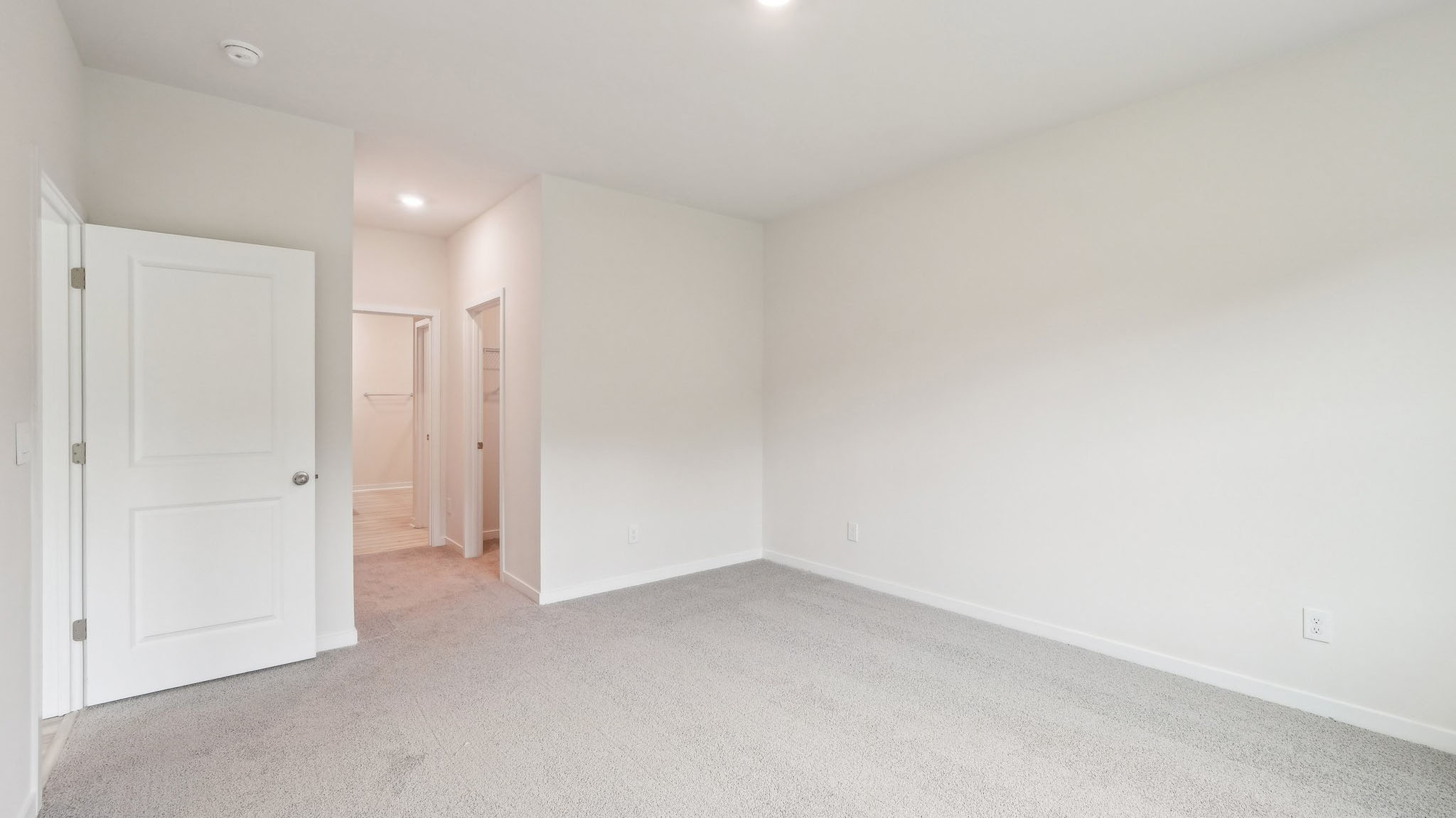 Carpeted bedroom with large window