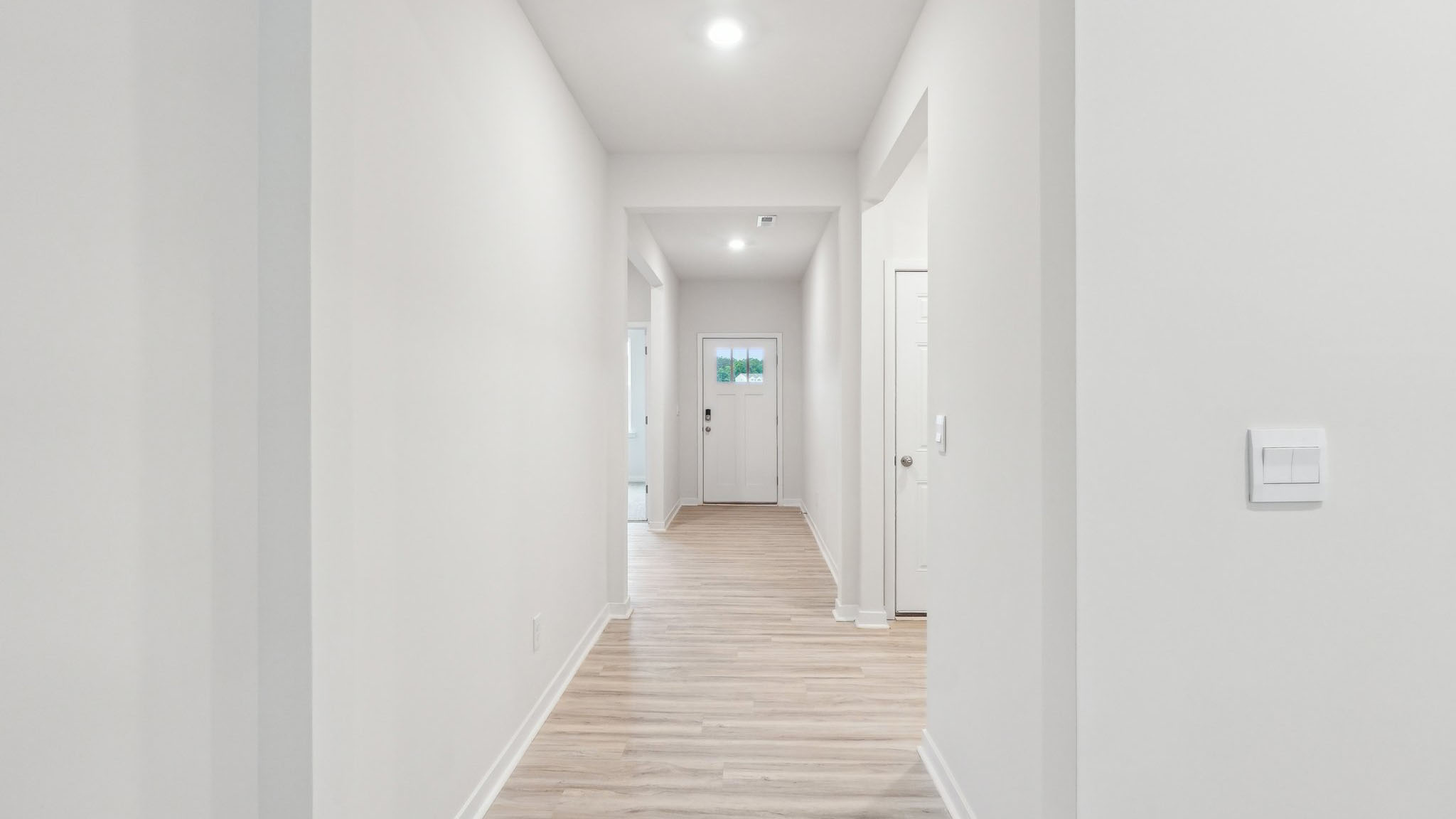 Welcoming foyer with vinyl flooring and large window