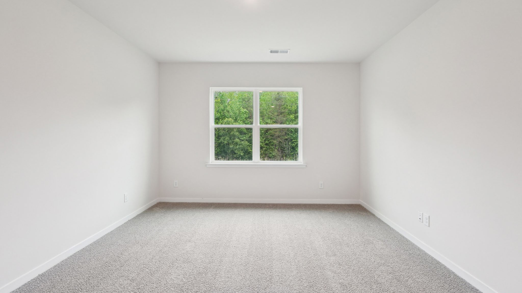 Carpeted bedroom with large window