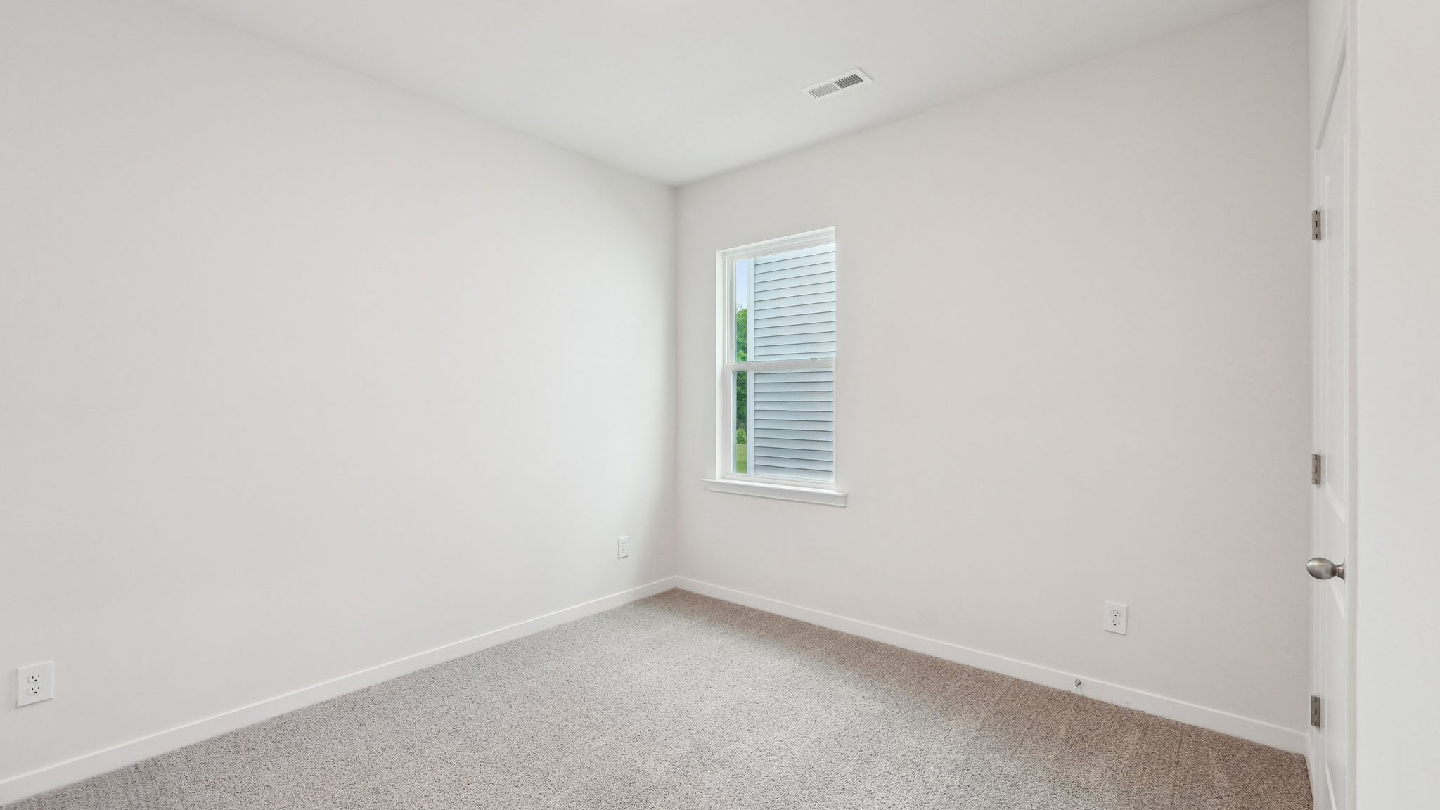 Carpeted bedroom with large window