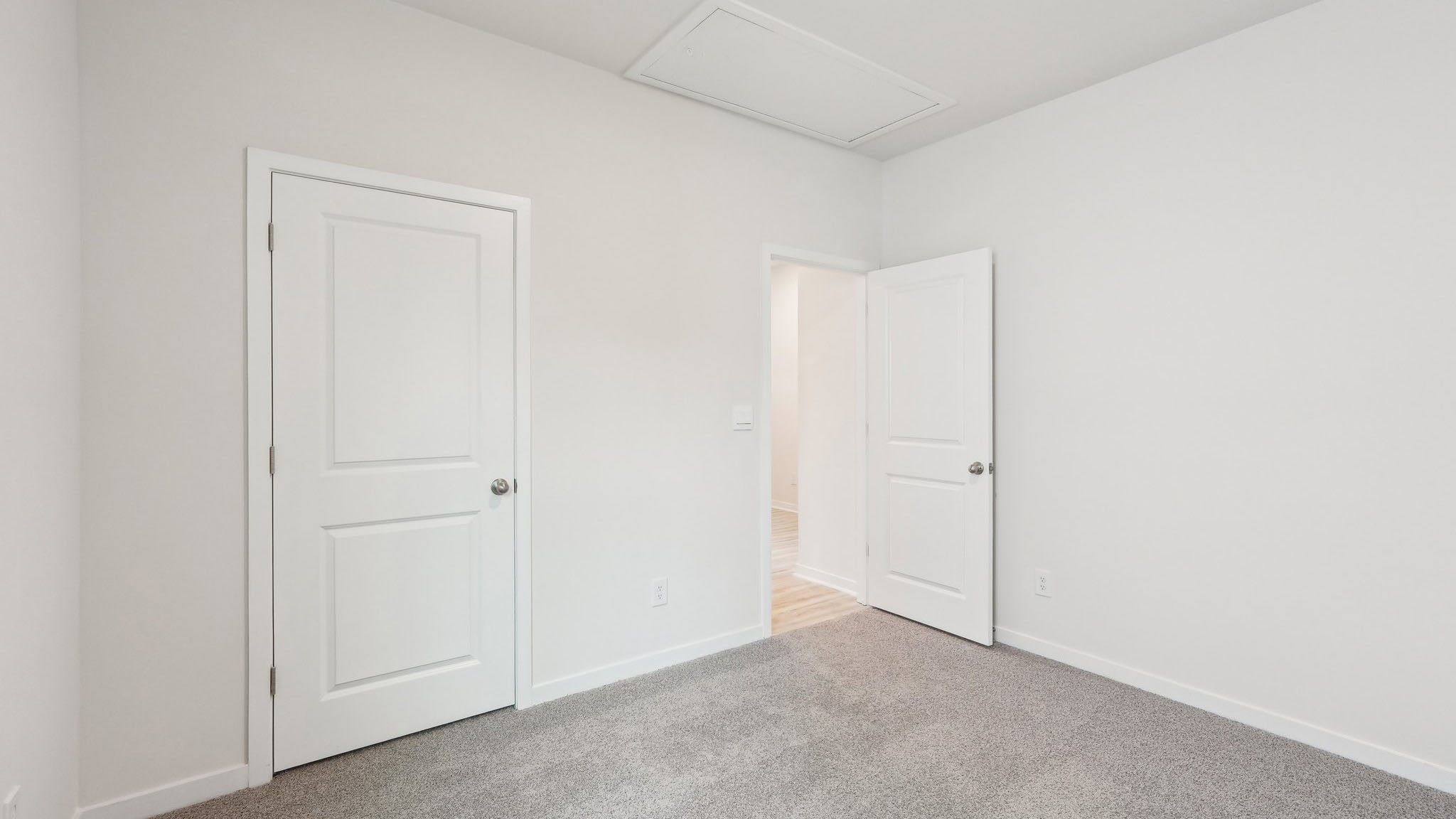 Carpeted bedroom with large window