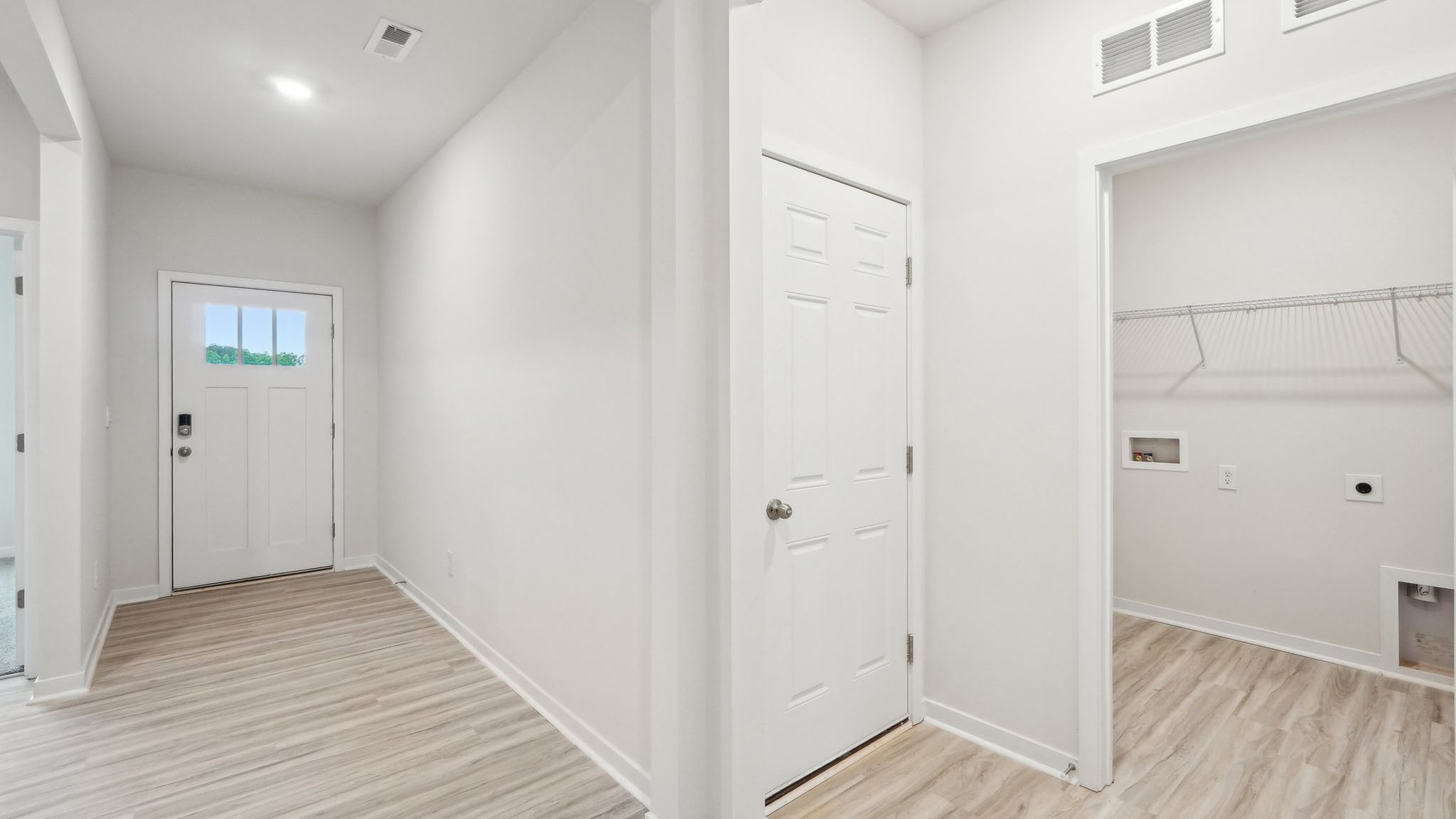 Welcoming foyer with vinyl flooring and large window