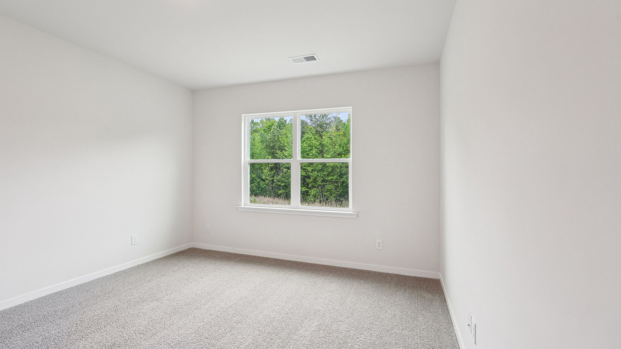 Carpeted bedroom with large window