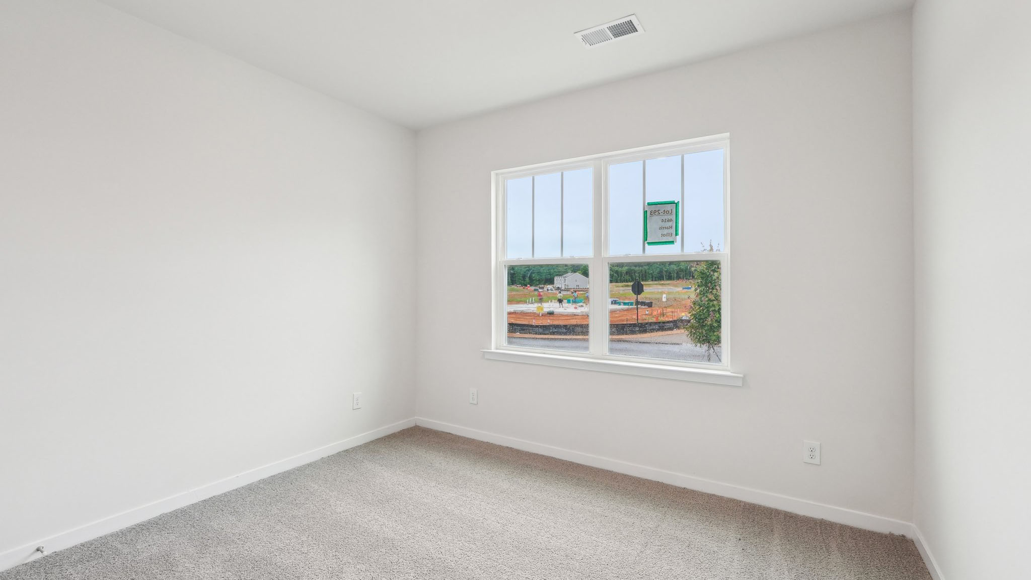 Carpeted bedroom with large window