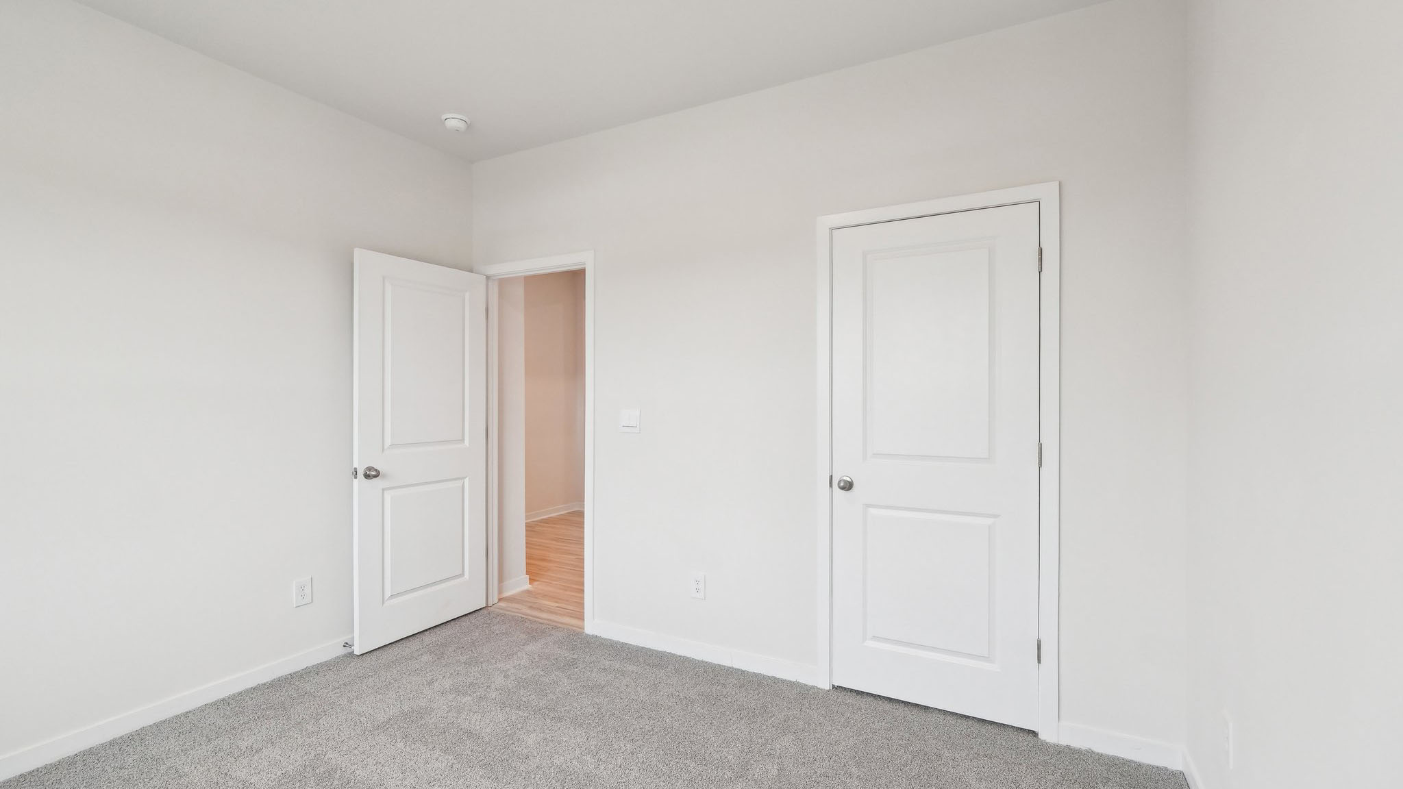 Carpeted bedroom with large window