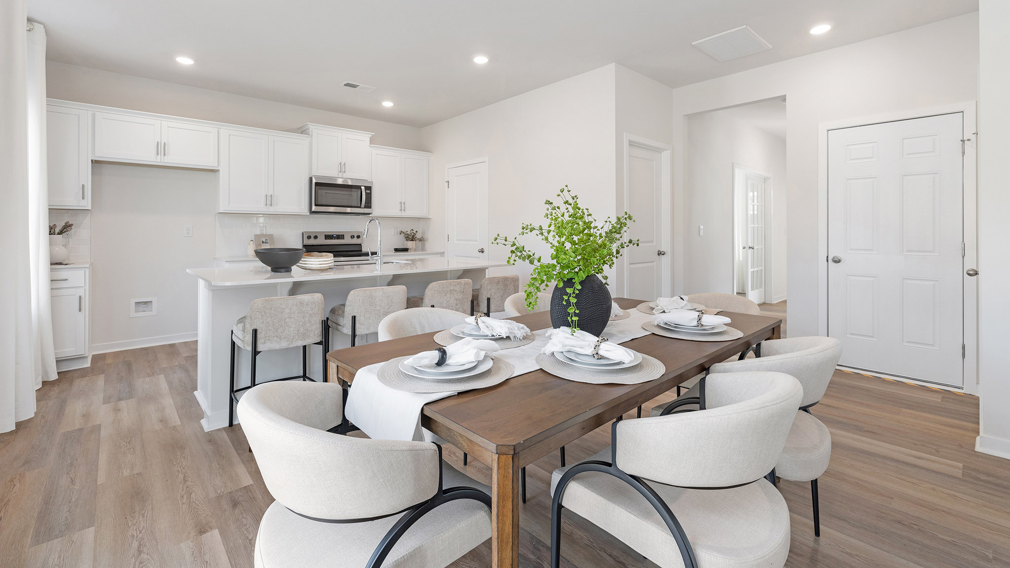 Dining area by kitchen, beside sliding glass doors outside