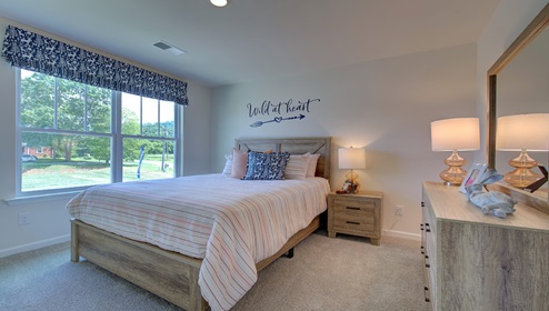 carpeted bedroom with large window