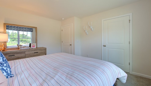 carpeted bedroom with large window