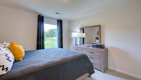 carpeted bedroom with large window