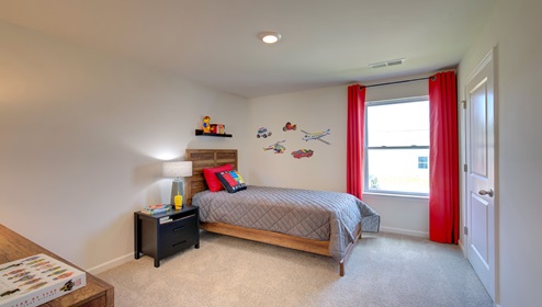 carpeted bedroom with large window