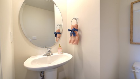 Powder bathroom with small sink and toilet