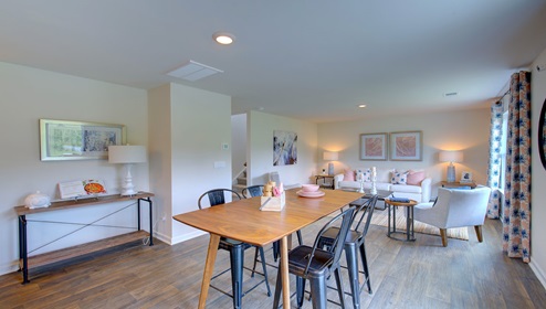 Breakfast area beside kitchen and living room with sliding glass back door