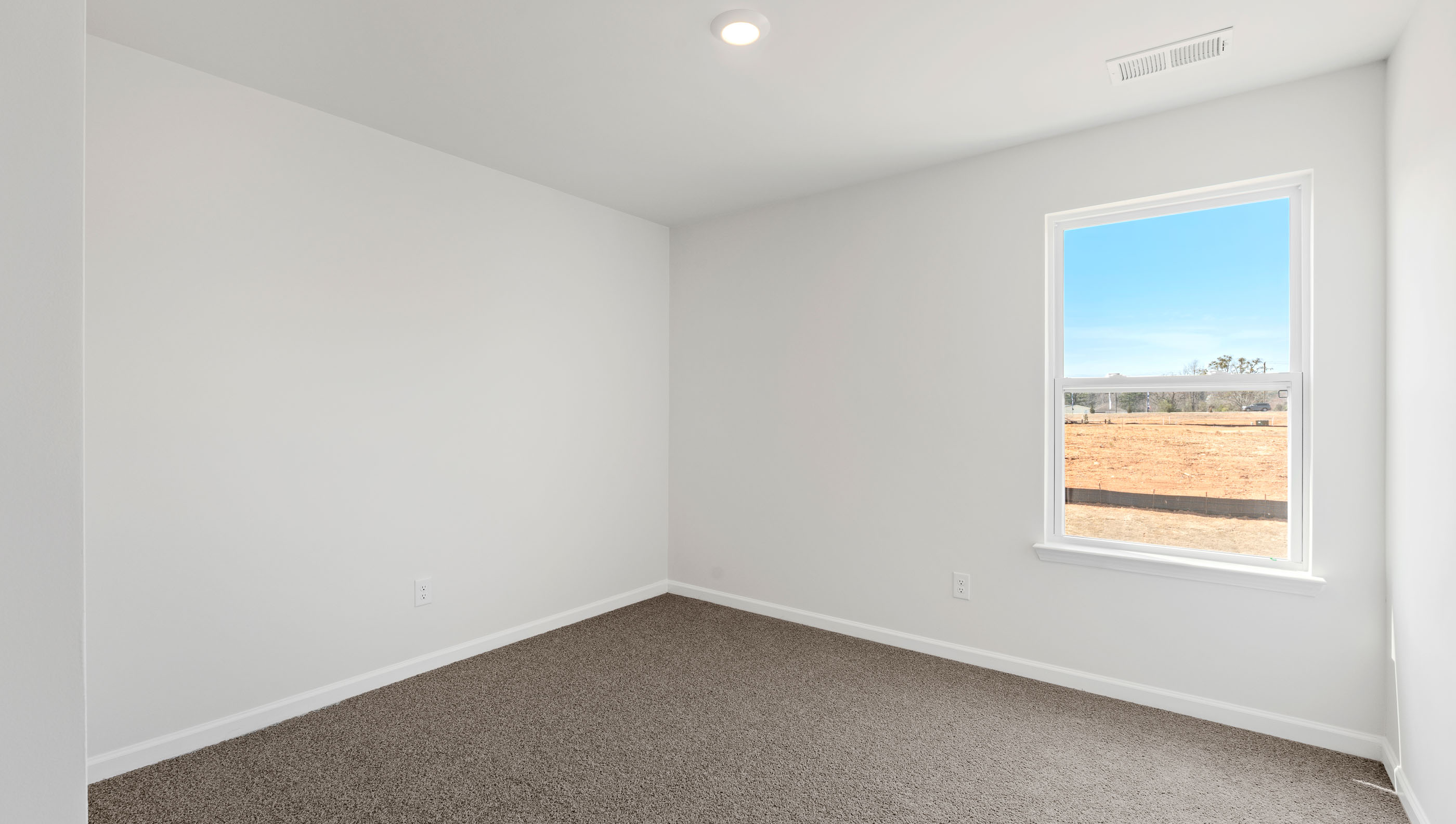 Carpeted bedroom with large window