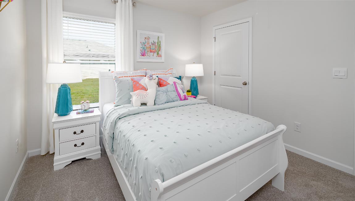 Carpeted bedroom with large windows