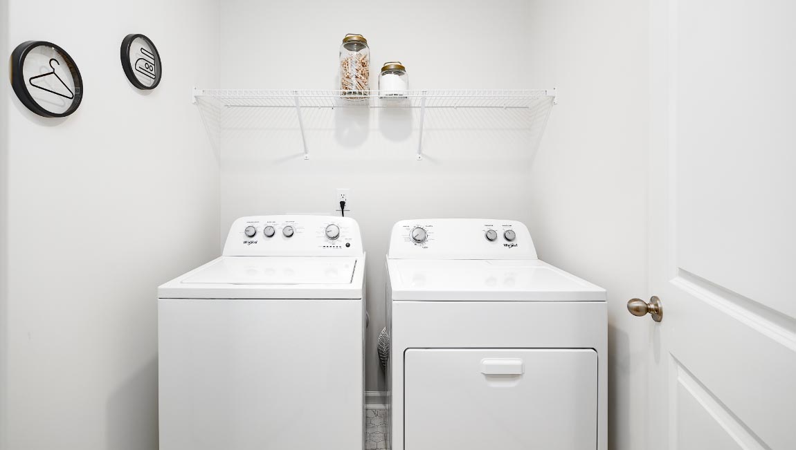 Laundry room with washer, dryer and shelving