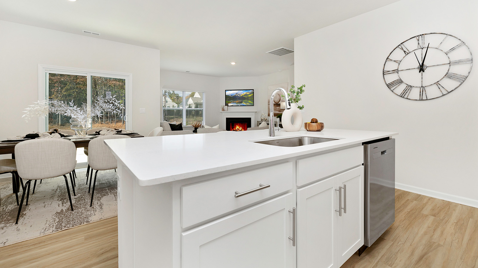 Kitchen and island with white cabinets and subway tiles and stainless steel subway tiles