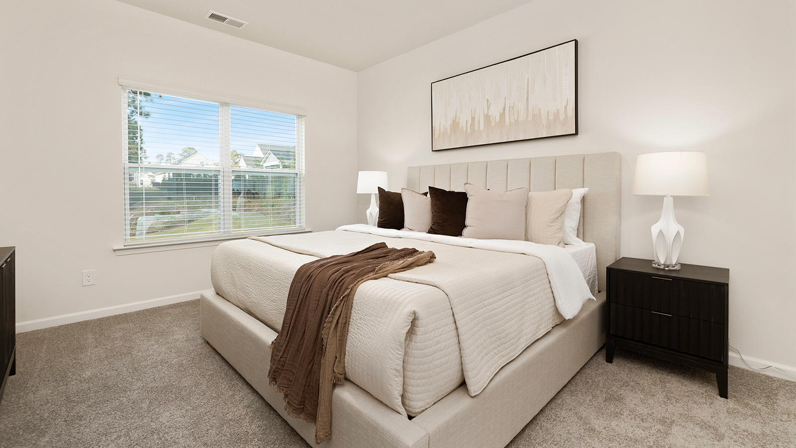 Carpeted bedroom with large window