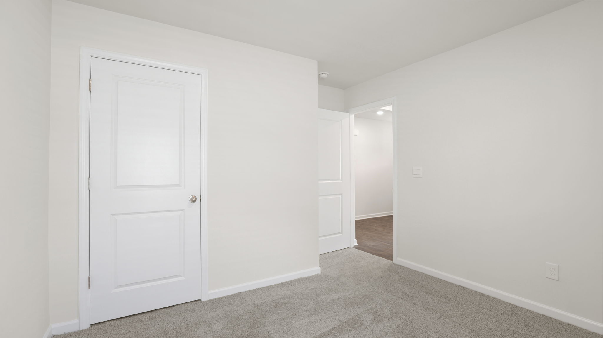 Carpeted bedroom with closet