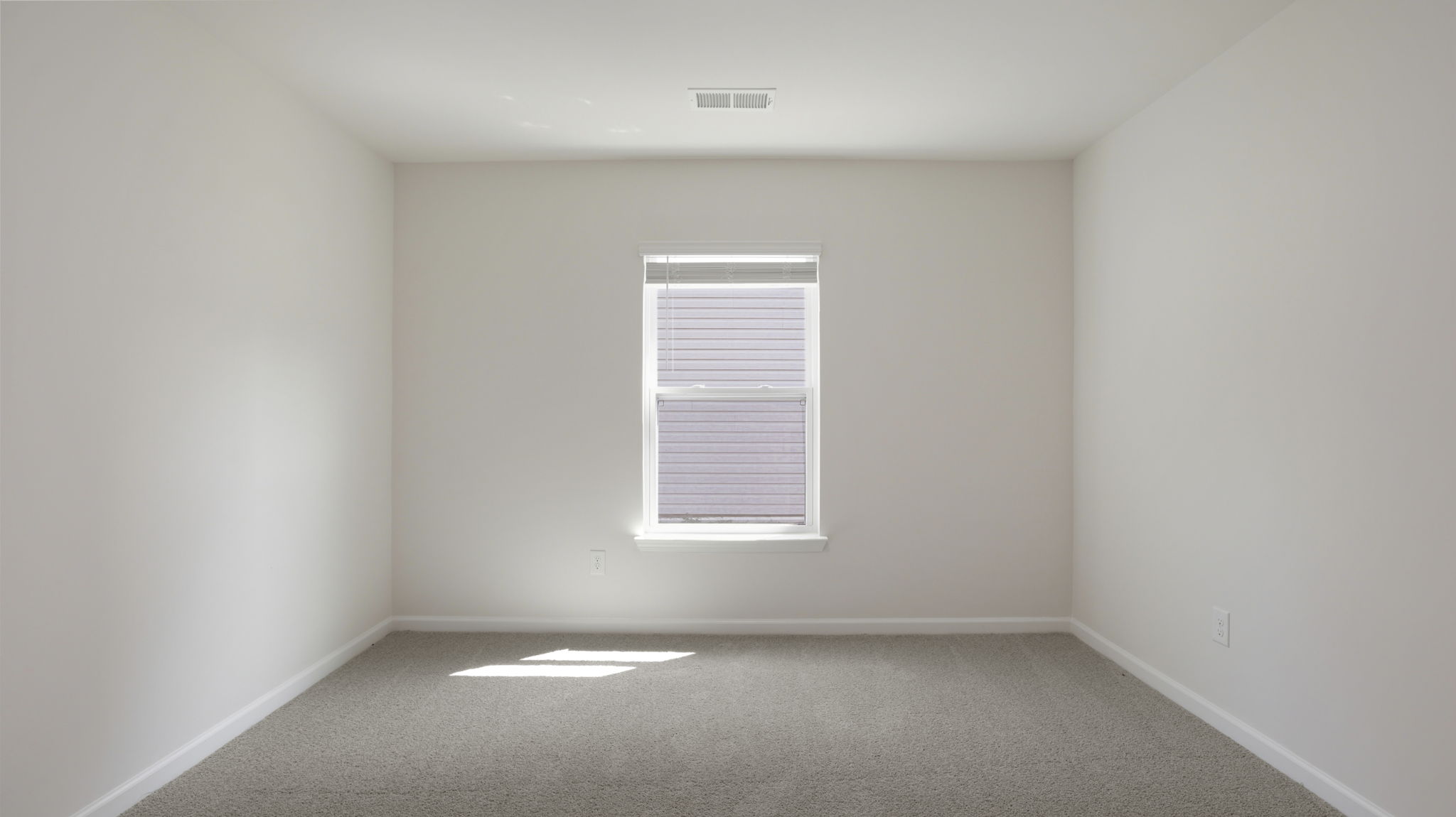 Carpeted bedroom with large windows