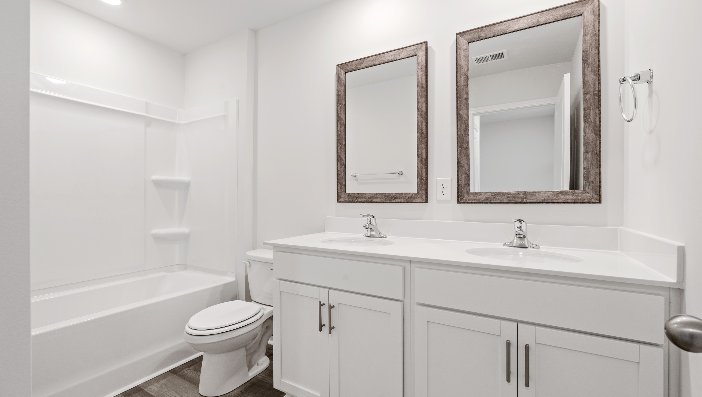 Bathroom with double vanity and bathtub