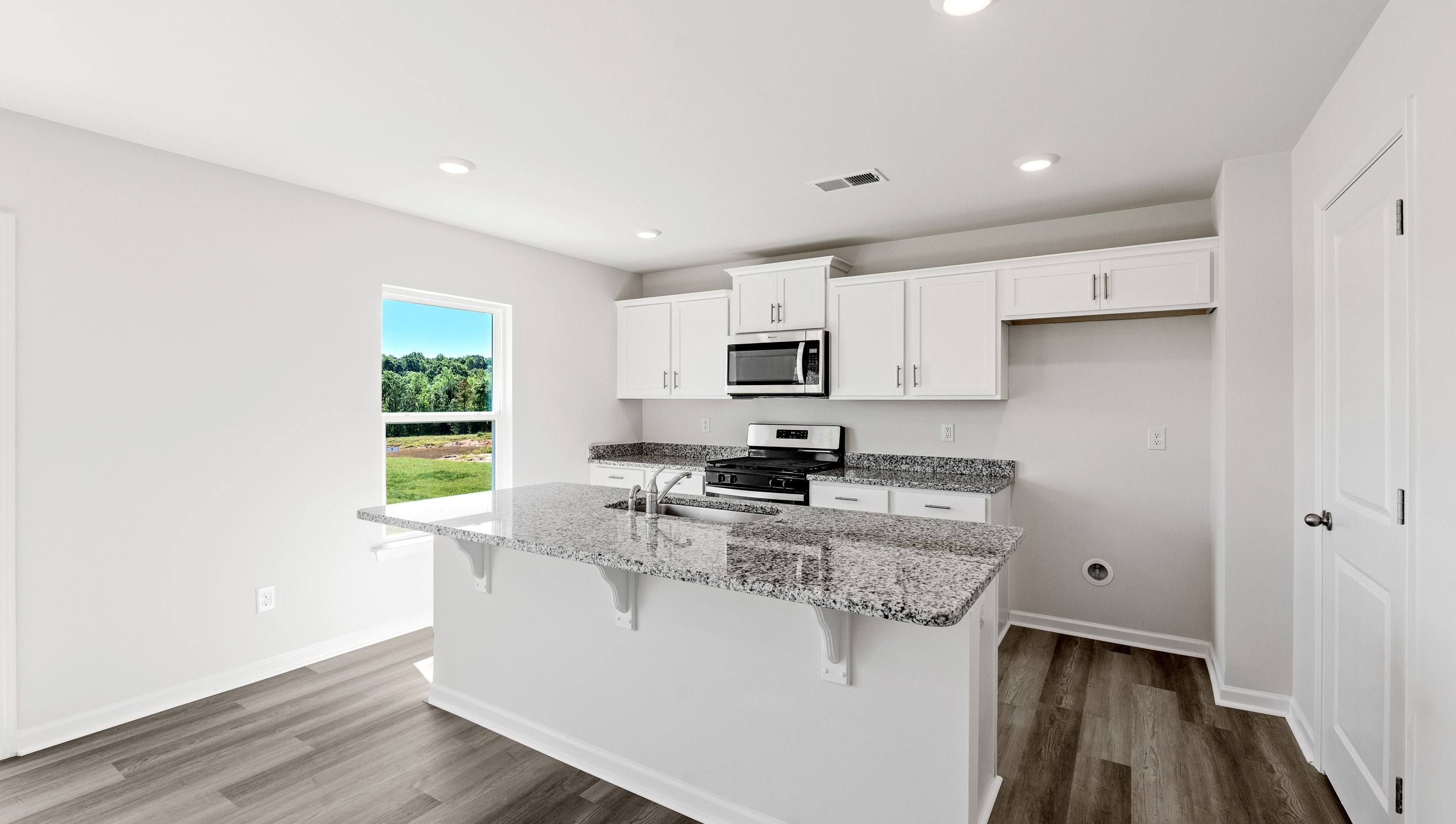 Open kitchen with large island and windows