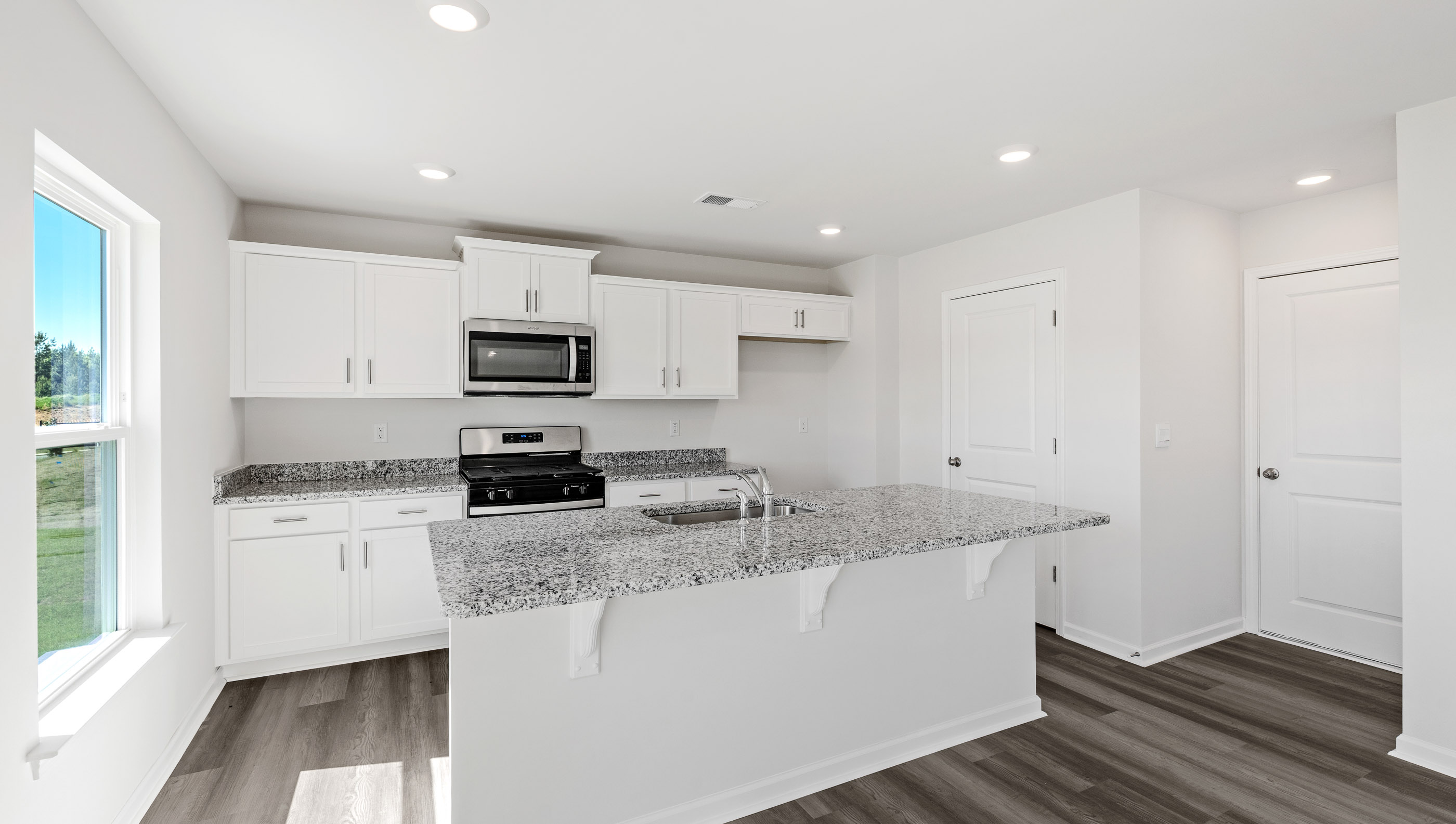 Open kitchen with large island and windows