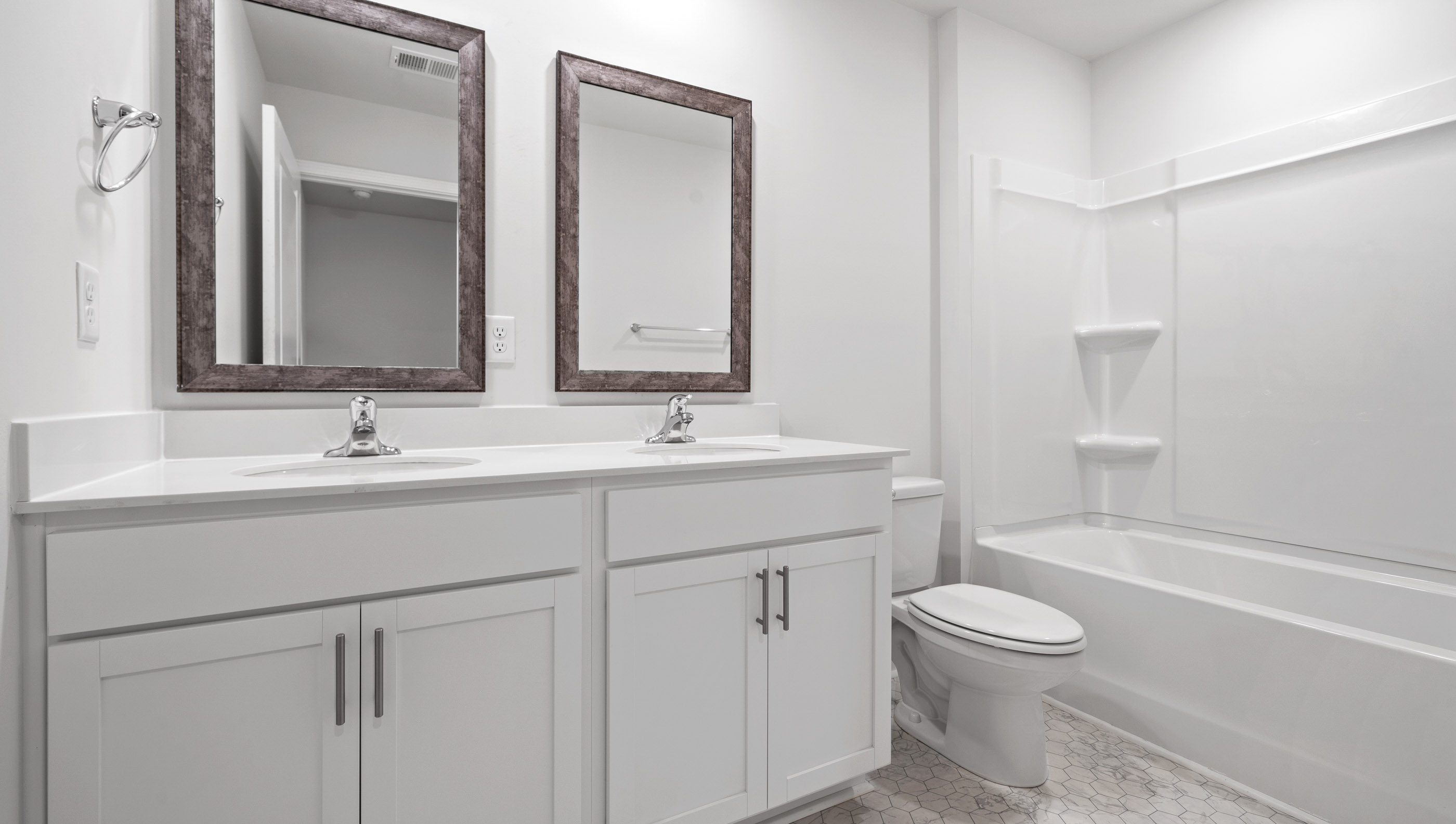 Bathroom with dual vanity and bathtub