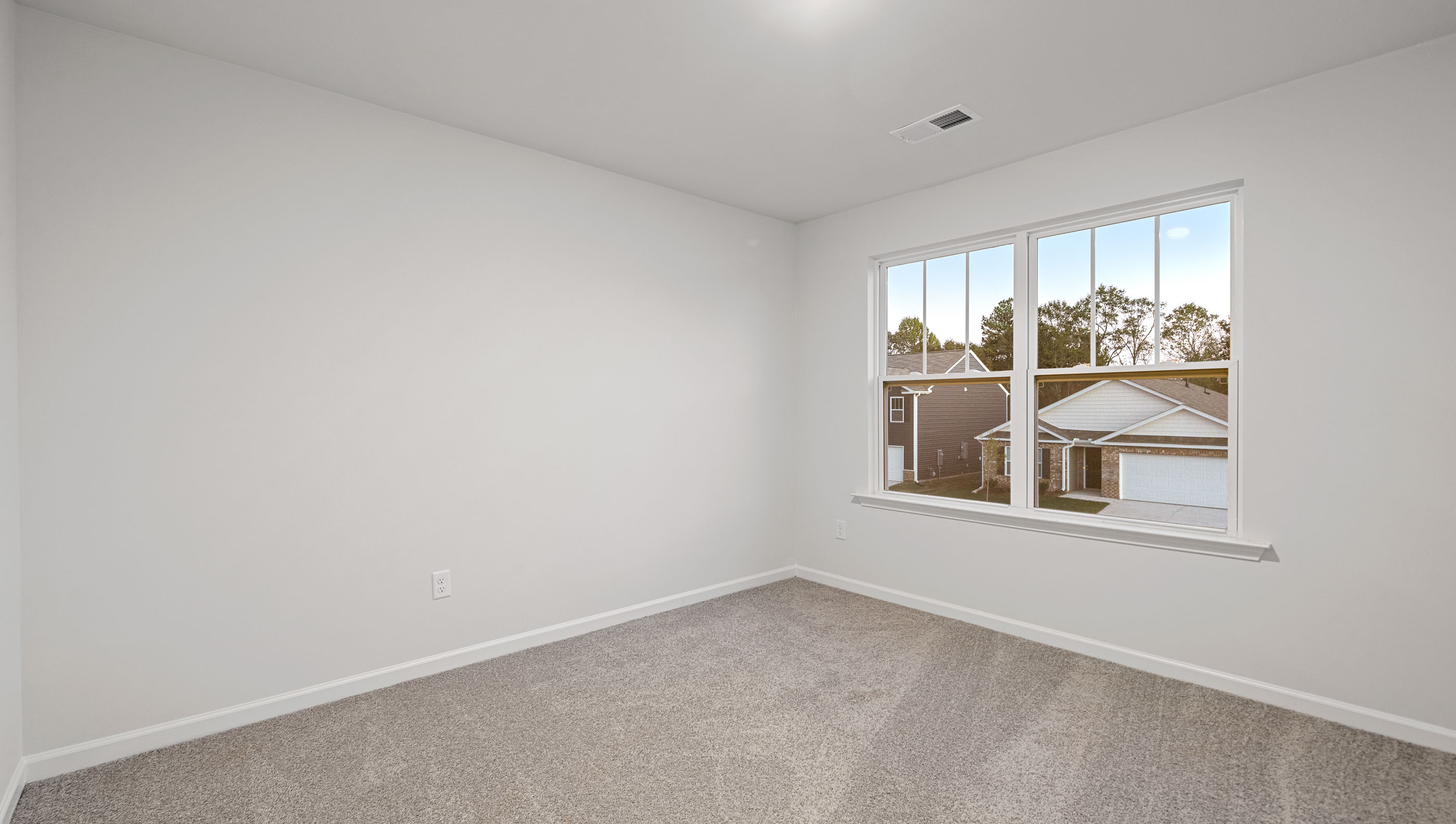 Carpeted bedroom with large windows