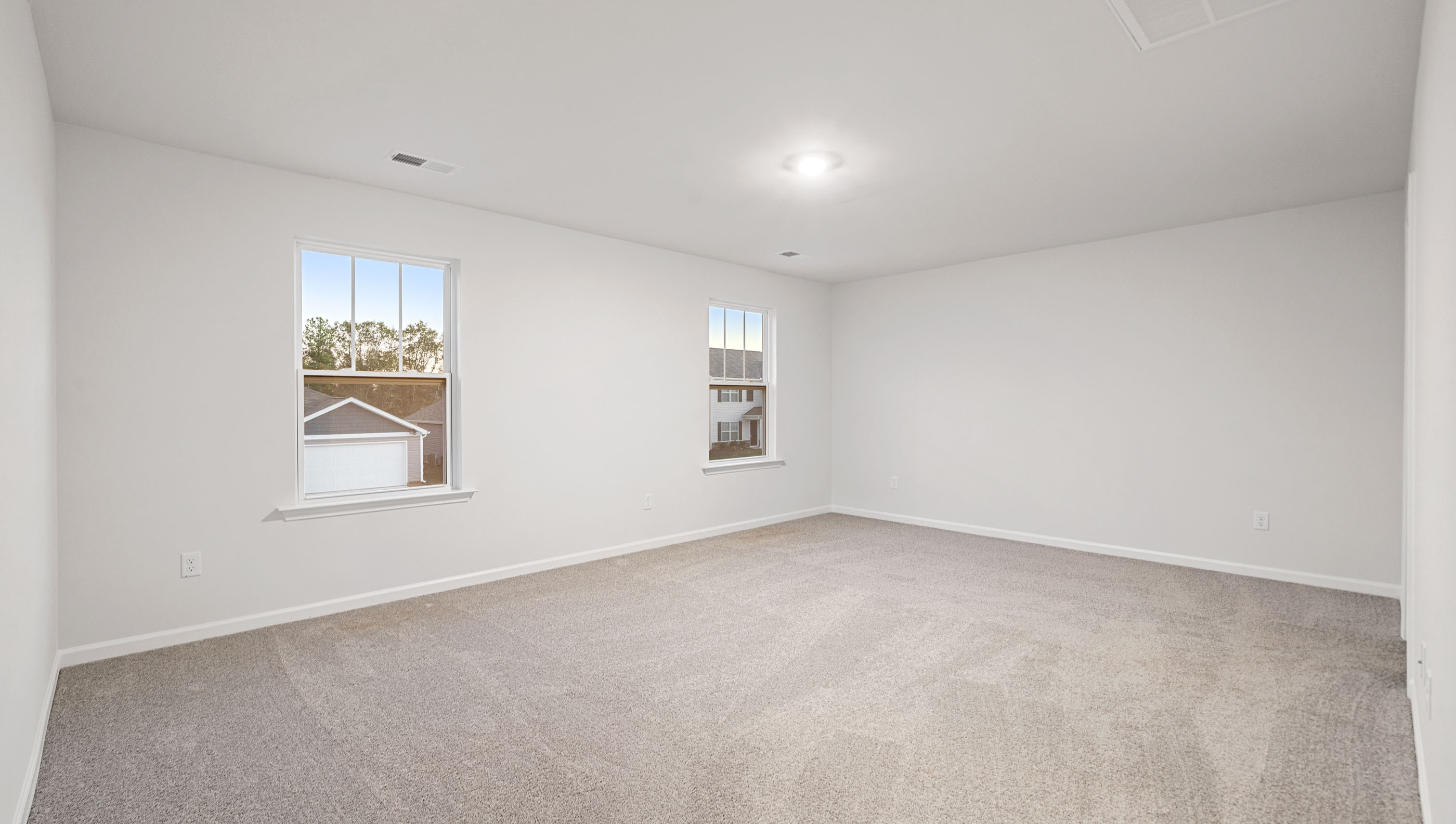 Carpeted bedroom with large windowsCarpeted bedroom with large windows