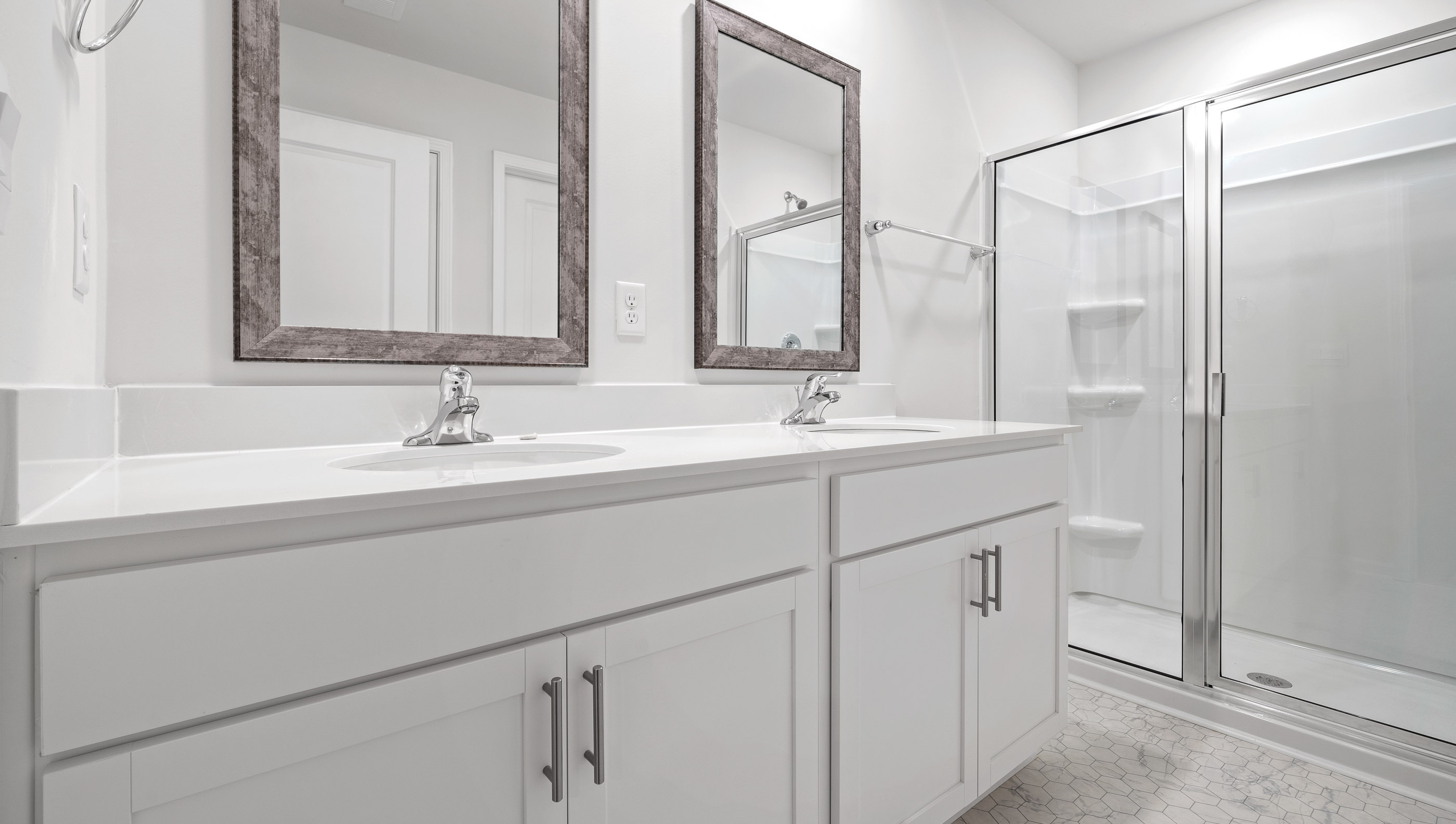 Primary bathroom with dual vanity and walk in shower