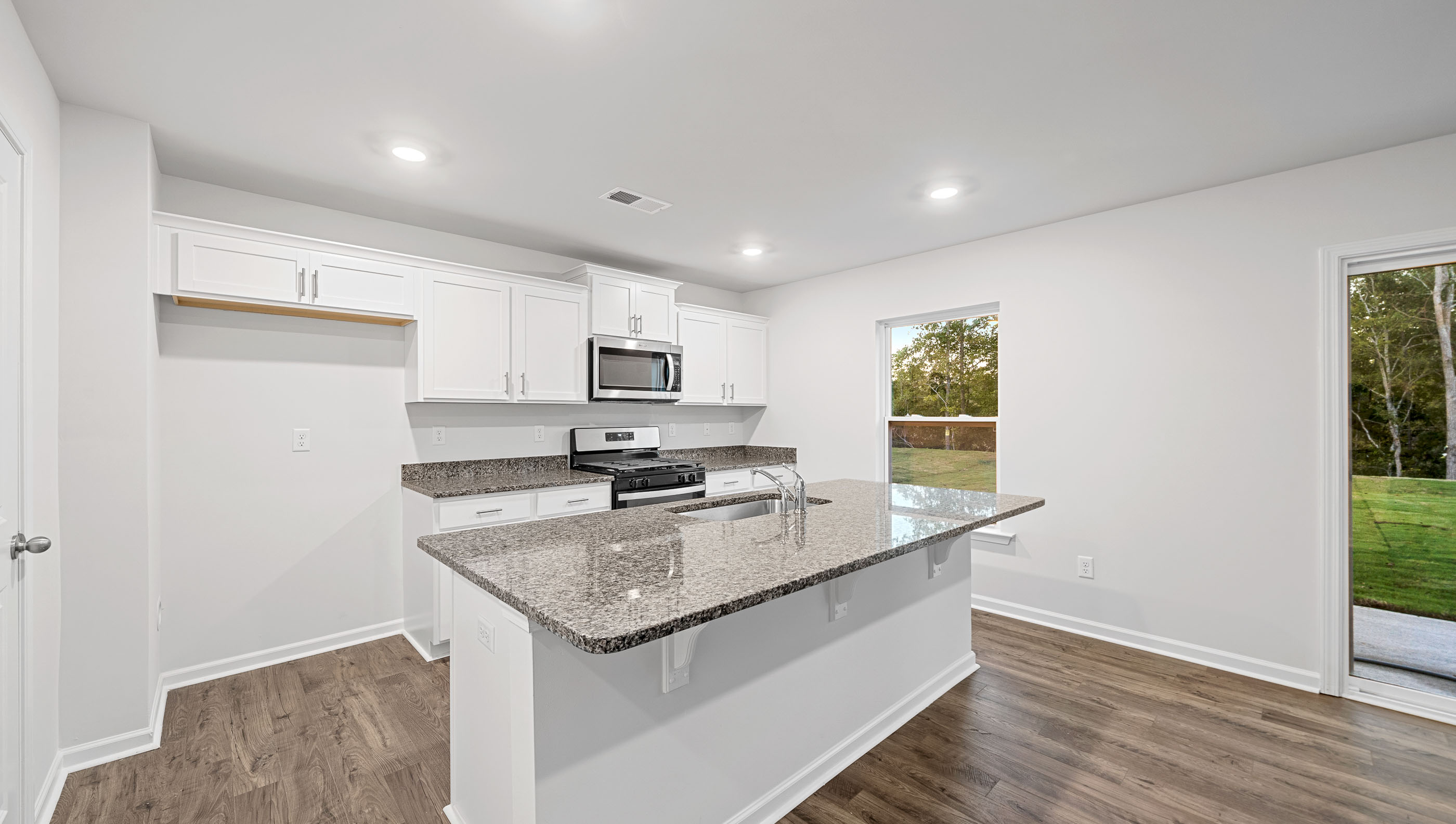 Open kitchen with large island and stainless steel appliances