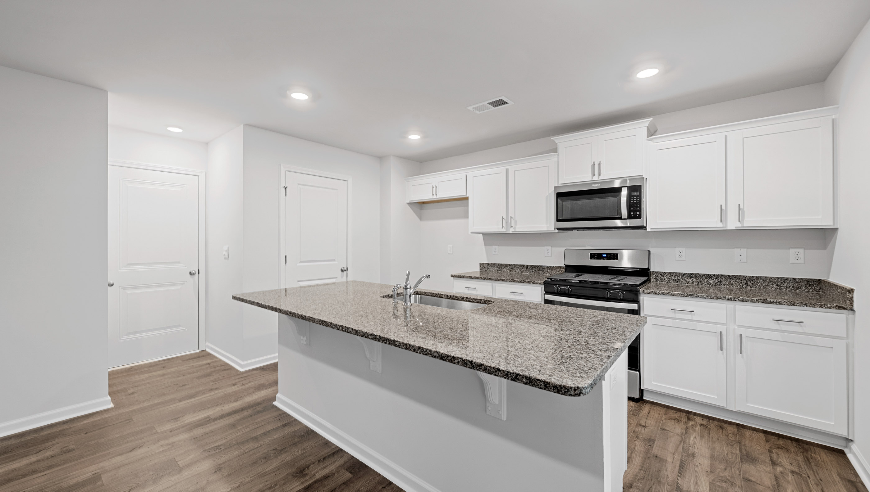 Open kitchen with large island and stainless steel appliances